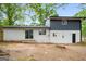An inviting backyard featuring a gray and white two-story home and sliding glass door entrance at 410 Queen Aliese Ln, Jonesboro, GA 30236