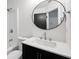 Updated bathroom featuring modern vanity, mirror, fixtures and a shower-tub combination at 410 Queen Aliese Ln, Jonesboro, GA 30236