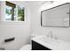 Bright bathroom with modern fixtures including vanity with black cabinets and solid surface countertop at 410 Queen Aliese Ln, Jonesboro, GA 30236