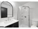Modern bathroom features a glass enclosed shower, white subway tile and updated vanity at 410 Queen Aliese Ln, Jonesboro, GA 30236
