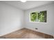A vacant bedroom features wood-look flooring, a bright window and natural light at 410 Queen Aliese Ln, Jonesboro, GA 30236