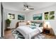 Bright bedroom features hardwood flooring, ceiling fan, windows, and neutral decor at 410 Queen Aliese Ln, Jonesboro, GA 30236