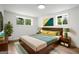 Staged bedroom featuring neutral decor, comfortable king bed and natural lighting at 410 Queen Aliese Ln, Jonesboro, GA 30236