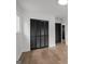 Bedroom features modern ceiling fan, wood floors and black doors to the closet at 410 Queen Aliese Ln, Jonesboro, GA 30236