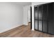 Clean bedroom features wood floors, black louvered closet doors and white trim at 410 Queen Aliese Ln, Jonesboro, GA 30236
