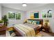 A beautifully staged bedroom with a modern aesthetic and filled with natural light at 410 Queen Aliese Ln, Jonesboro, GA 30236