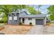 Charming two-story home featuring a gray-and-white painted brick, updated windows, and a well-manicured front yard at 410 Queen Aliese Ln, Jonesboro, GA 30236