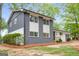 A modern two-story exterior featuring gray brick, white accents and large, bright windows at 410 Queen Aliese Ln, Jonesboro, GA 30236