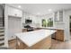 Modern kitchen with white cabinets, quartz countertops, stainless steel appliances, and hardwood floors at 410 Queen Aliese Ln, Jonesboro, GA 30236