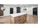 Bright, open-concept kitchen with hardwood floors and large center island at 410 Queen Aliese Ln, Jonesboro, GA 30236