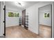 Bright living room with hardwood flooring, accent wall and modern shelving at 410 Queen Aliese Ln, Jonesboro, GA 30236
