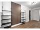 Bright living room with hardwood flooring, accent wall and modern shelving at 410 Queen Aliese Ln, Jonesboro, GA 30236