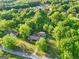 Overhead view of home revealing wooded lot and neighborhood access, emphasizing peaceful surroundings at 115 Linda Way, Fayetteville, GA 30215