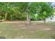 Expansive backyard with mature trees, providing shade and a natural setting for outdoor activities at 115 Linda Way, Fayetteville, GA 30215