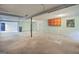 Open basement area with concrete flooring ready for renovation, featuring natural light and utility access at 115 Linda Way, Fayetteville, GA 30215