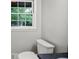 Bathroom featuring a white toilet and a window at 115 Linda Way, Fayetteville, GA 30215