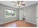 Bright bedroom featuring hardwood floors, a ceiling fan, and neutral walls at 115 Linda Way, Fayetteville, GA 30215