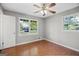 Bedroom with wood floor, ceiling fan, and windows to let in light at 115 Linda Way, Fayetteville, GA 30215