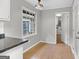 Eat-in kitchen with gray walls, bright windows and light wood-look flooring offer a cozy dining area at 115 Linda Way, Fayetteville, GA 30215