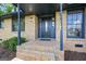 Charming front entryway featuring a decorative door, brick steps, and classic lighting at 115 Linda Way, Fayetteville, GA 30215