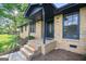 Inviting front porch with brick steps and stylish black accents on the door and pillars at 115 Linda Way, Fayetteville, GA 30215