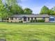 Charming brick home with a lush, well-manicured front yard and inviting curb appeal at 115 Linda Way, Fayetteville, GA 30215