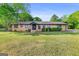 Well-maintained ranch-style home featuring a manicured lawn and established landscaping at 115 Linda Way, Fayetteville, GA 30215