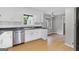 Bright eat-in kitchen with stainless steel dishwasher, light gray walls, and light wood floors offers a cozy space for dining at 115 Linda Way, Fayetteville, GA 30215