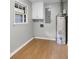 Functional laundry room featuring gray walls, light wood-look flooring, and natural light offers efficiency at 115 Linda Way, Fayetteville, GA 30215