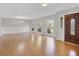Bright living room featuring laminate floors, large windows, and a charming chandelier at 115 Linda Way, Fayetteville, GA 30215