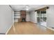 Spacious living room with wood-look floors, brick fireplace, and sliding glass doors offers comfortable living at 115 Linda Way, Fayetteville, GA 30215