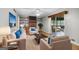 Staged living room with wood-look floors, brick fireplace, and sliding glass doors offer comfortable living at 115 Linda Way, Fayetteville, GA 30215