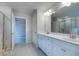 Bathroom featuring a double vanity, walk-in shower, and neutral colored accents at 1816 Quaker St, Hampton, GA 30228