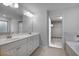 Bright bathroom with double vanity, large mirror, and tiled flooring at 1816 Quaker St, Hampton, GA 30228