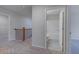 Bathroom view from the hallway, with a combination tub and shower, white fixtures, and tile flooring at 1816 Quaker St, Hampton, GA 30228