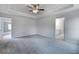 Spacious bedroom featuring a tray ceiling, fan, and access to an ensuite bathroom at 1816 Quaker St, Hampton, GA 30228
