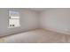 A cozy bedroom is brightened by a window and has neutral carpet to match any style of decor at 1816 Quaker St, Hampton, GA 30228