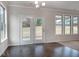 Dining room with hardwood floors, modern light fixture and double doors leading to the outside at 1816 Quaker St, Hampton, GA 30228