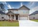 Beautiful two-story home featuring brick and siding exterior, manicured lawn, and a two-car garage at 1816 Quaker St, Hampton, GA 30228