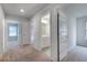 Hallway view with carpet and doors leading to a bathroom and other rooms in the home at 1816 Quaker St, Hampton, GA 30228