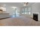 Open-concept living room with fireplace, ceiling fan, recessed lighting and an adjacent kitchen area at 1816 Quaker St, Hampton, GA 30228