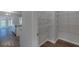 Walk-in closet adjacent to kitchen features built-in shelves and hardwood flooring at 1816 Quaker St, Hampton, GA 30228