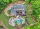 Aerial view of a luxurious property featuring a sprawling home, pool area, and landscaped backyard at 95 Weslyan Way, Oxford, GA 30054