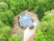 Stunning aerial view of a grand estate with a circular driveway, lush landscaping, and a private pool oasis at 95 Weslyan Way, Oxford, GA 30054