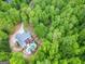 Aerial shot showcasing a home with a spacious backyard, pool, deck, and mature trees at 95 Weslyan Way, Oxford, GA 30054