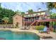 Backyard oasis with a large pool, patio seating, and a multilevel deck perfect for entertaining at 95 Weslyan Way, Oxford, GA 30054