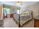 Serene bedroom featuring a wrought iron bed, elegant decor, and a sunny window at 95 Weslyan Way, Oxford, GA 30054