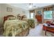 Charming bedroom featuring two beds with decorative linens, a ceiling fan, and tasteful decor at 95 Weslyan Way, Oxford, GA 30054