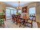Bright dining room showcases a traditional chandelier, floral painting, and wooden table at 95 Weslyan Way, Oxford, GA 30054