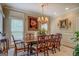 Charming dining room features a large wooden table, chairs, and elegant chandelier at 95 Weslyan Way, Oxford, GA 30054